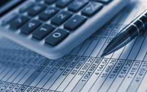 computer keyboard and pen on accounting sheet